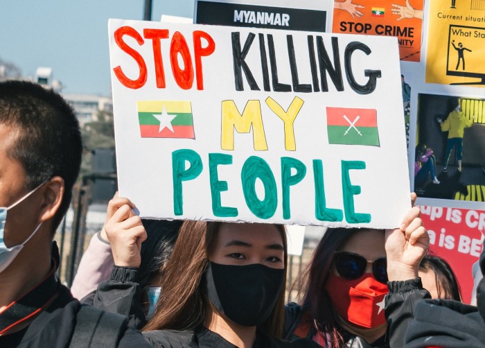 A protester holds a sign that reads 'Stop killing my people' during demonstrations against the coup in Myanmar/Burma.