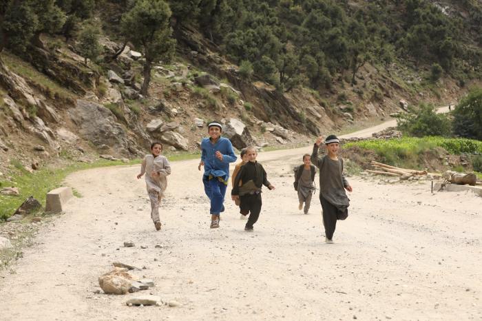 Children running on sand in Nuristan, Afghanistan.